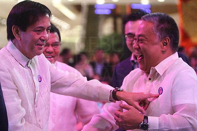 Still time for a good laugh. Cebu City Mayor Michael Rama (left) points to the Robinsons logo sticker on the barong of Cebu Gov. Hilario Davide III and jokes that the prominent letter "R" stands for "Rama." Vice Mayor Edgardo Labella and Frederick Go, president and COO of Robinsons Land, behind them, share the light moment during the opening of Robinsons Galleria Cebu. (CDN PHOTO/TONEE DESPOJO)