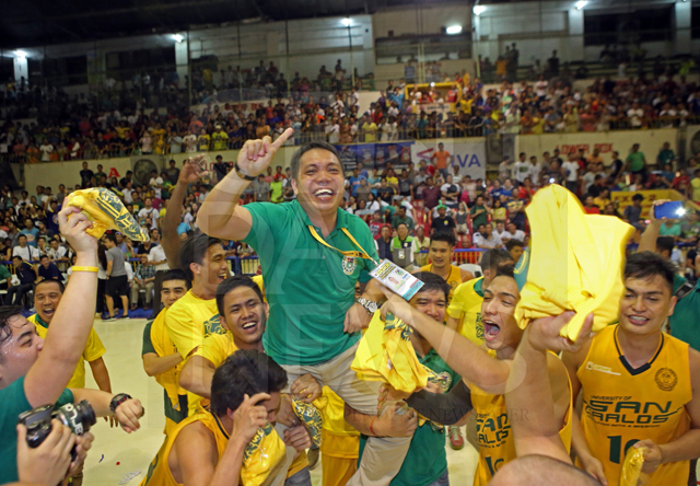 USC Warriors Head Coach Britt Carlo Reroma is carried by his team after winning the Cesafi men's hoop crown last October.