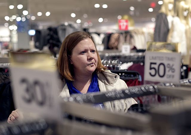 In this Nov. 28, 2015 file photo, Janae Melvin shops for gifts at Forever 21 in Kansas City. Melvin is cutting back on Christmas spending to save for a home and a family vacation next year.  (AP PHOTO)