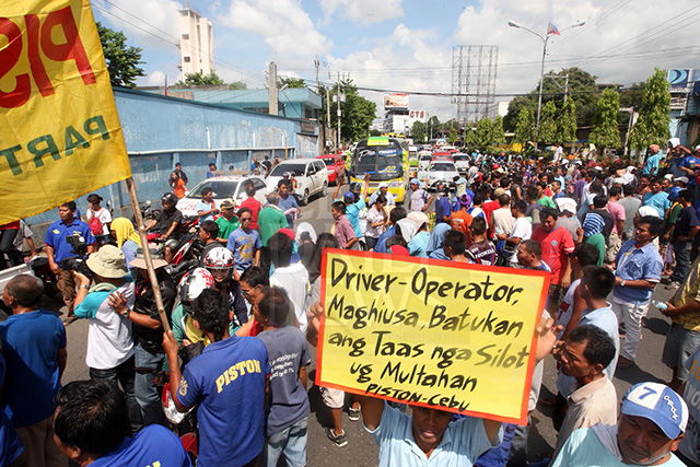 Several passenger buses were blocked by striking drivers along Natalio Bacalso Ave. in front of the office of the Land Transportation Office in this CDN file photo. The striking drivers protested the higher traffic violation fees imposed by DOTC.