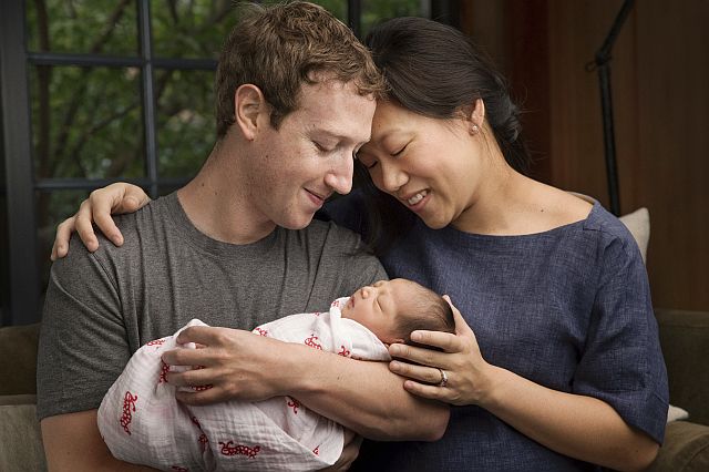 Max Chan Zuckerberg is held by her parents, Mark Zuckerberg and Priscilla Chan Zuckerberg. (Mark Zuckerberg via AP)