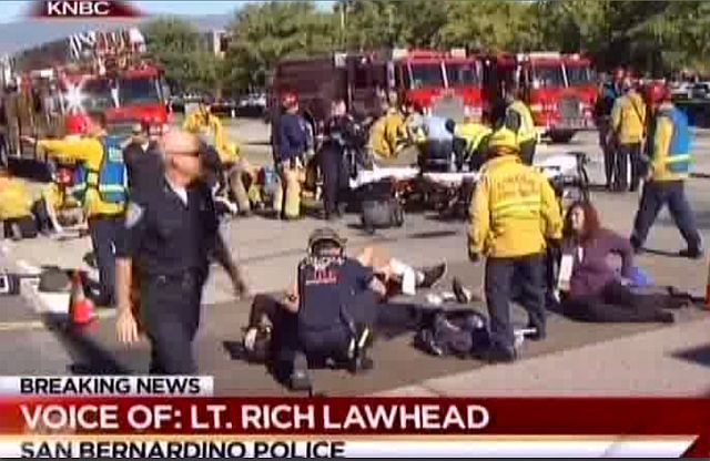 First responders attend to people outside a Southern California social services center in San Bernardino, where one or more gunmen opened fire, shooting more than 25 people. (AP PHOTO)