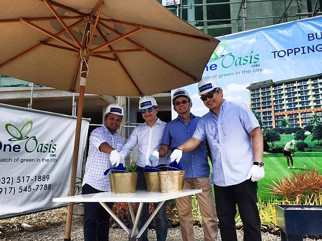 Project Development Officer, Archie Igot; Assistant vice president for sales Boler Binamira; Vice president for strategic business development Allan Alfon; and FLI first vice president and VisMin cluster head Tristan Las Marias, perform the ceremonial topping off of One Oasis' fifth building today. (CDN PHOTO/VANESSA CLAIRE LUCERO)