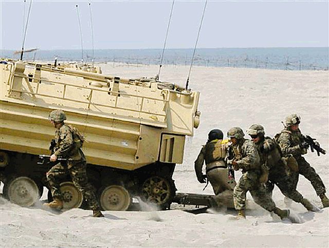 US troops disembark from their amphibious assault vehicle during a combined assault exercise at a beach facing one of the contested islands off the South China Sea known as Scarborough Shoal in the West Philippine Sea  in this April 21, 2015 file photo at the Naval Education and Training Command in San Antonio, Zambales province. (AP FILE PHOTO)
