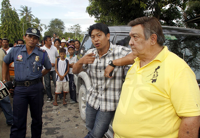 Provincial Board Member Celestino "Tining" Martinez III (center), then a congressional candidate, asks Supt. Julian Entoma to check the vehicle of political rival Benhur Salimbangon for possible presence of firearms in this 2010 file photo. His father, Bogo City Mayor Celestino "Junie" Martinez, Jr. listens. The standoff led to the filing of grave coercion charges against the Martinezes. (CDN FILE PHOTO)
