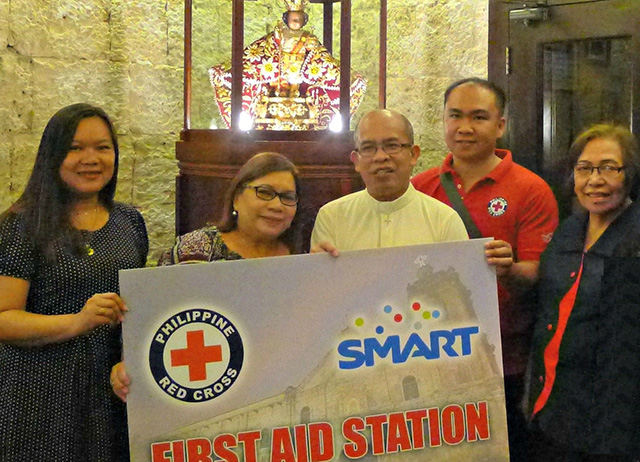 From left are Smart Public Affairs junior manager NN Navarro, Smart Public Affairs-VisMin senior manager Maria Jane Paredes, Fr.  Mejares and Red Cross Cebu Chapter Service representative Joseph Doniel Resma. (CONTRIBUTED PHOTO)