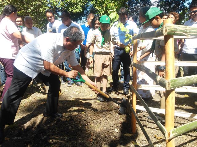 Education Secretary Bro. Armin Luistro shovels soil onto a narra sapling named after him and planted within the lot donated by Dr. Romulo Davide to Colawin Elementary School. (CDN PHOTO/VICTOR ANTHONY V. SILVA)