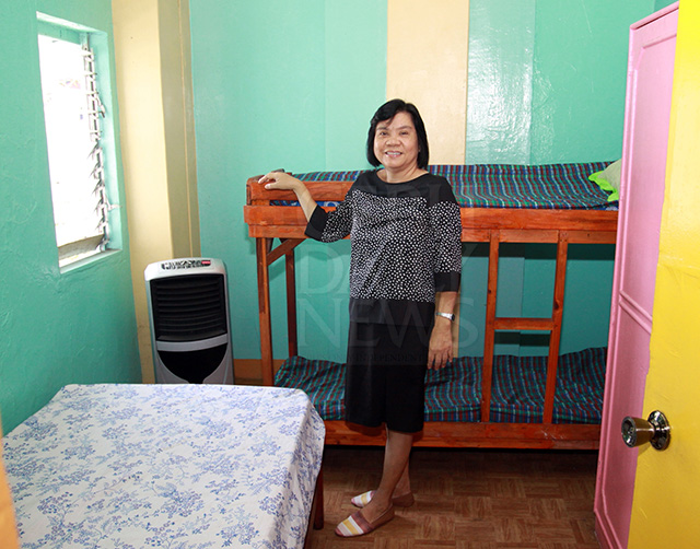 Virginia Rojas, a retired accountant, shows the room where her guests will stay. (CDN PHOTO/LITO TECSON)