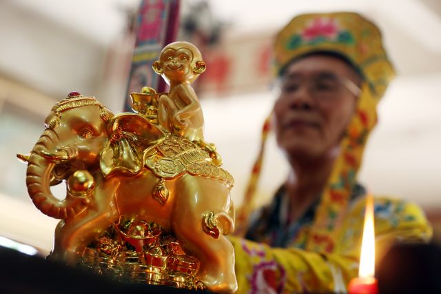 A miniature golden figure of a monkey sitting atop an elephant is on display as Taoist Grand Minister Rev. Fr. Wong Seng Tian performs a ritual in welcoming the Year of the Monkey at Sheng Lian Temple in Quezon City. (INQUIRER PHOTO)