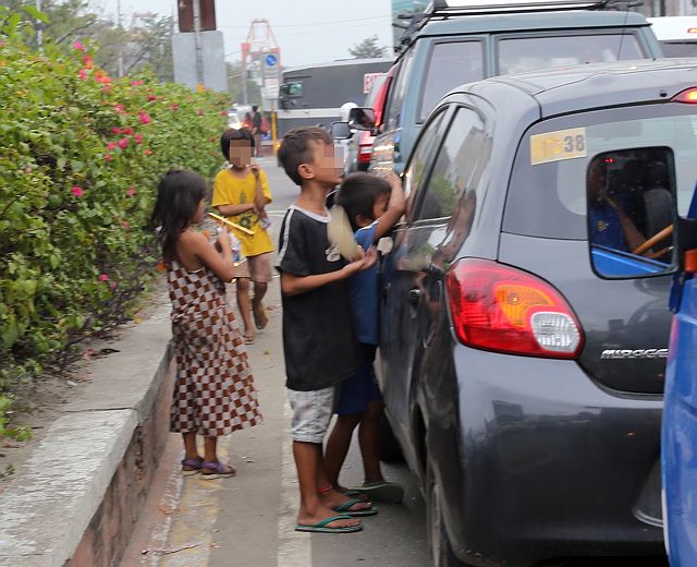 SILOY IS WATCHING: Street children continue its flight on the street such as this on Pope John Paul II asking for coins to motorists which endangering them. ATTENTION MOTORIST: AN ORDINANCE BY NOT GIVING ANY ALMS TO STREET CHILDREN IS PROHIBITED TO DISCOURAGE CHILDREN FROM GOING ON THE STREETS