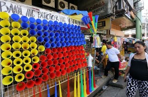 TOROTOT FOR NEW YEAR/DEC. 30, 2015: A display of "Torotot" with three colors Red, Yellow and Blue that form's the Philippine Flag and a message of "Bawal and Papotok Mag Torotot na lang Tayo" on the top portion that is on sale at Osmeña Blvd in preparation of the New years Eve celebration.(CDN PHOTO/JUNJIE MENDOZA)