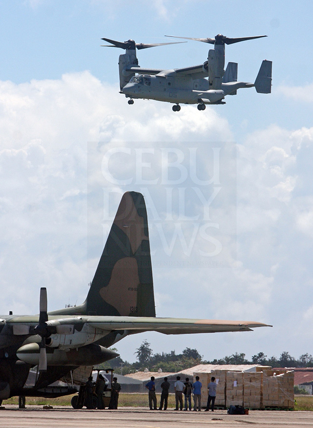 A V-22 Osprey of the U.S. Marines hovers above an Indonesian C-130 plane at the Mactan Benito Ebuean Air Base during a humanitarian mission in 2013. The government is considering the air base among the military sites that U.S. troops will be allowed to use under the Enhanced Defense Cooperation Agreement. (CDN FILE PHOTO)