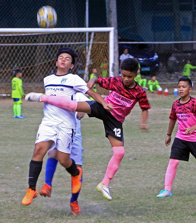 SINULOG 2016 FOOTBALL CUP/JAN.09,2016:Don Bosco United booter manage to kick the  ball away from Springdale booter during their game in Sinulog 2016 Football Cup at Don Bosco football field.(CDN PHOTO/LITO TECSON)