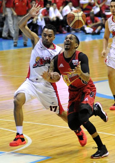 Cris Ross of SMB loses the ball on the way to the basket off Cris Exeminiano of Alaska , at the Smart Araneta. (INQUIRER PHOTO)