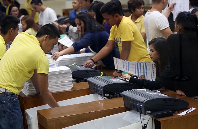 Workers at National Printing Office in Quezon City undergo orientation and verification process of Precinct Count Optical Scan (PCOS) machines. The Commission on Elections is set to have a dry run for ballot printing in the coming days. (INQUIRER PHOTO)