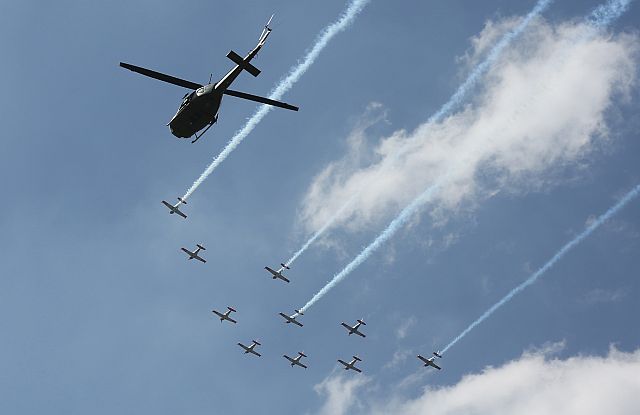 Italian-made SF 260 jet planes fly in unison in the skies of Quezon City in preparation for the Edsa People Power 30th anniversary tomorrow. (INQUIRER PHOTO)