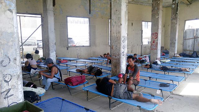 HOME FOR NOW. The 56 street dwellers sleep on stretcher beds provided by the Cebu  city government at the Compaña Maritima building following the closure of the Devotee City. (CDN PHOTO/JULI ANN SIBI)