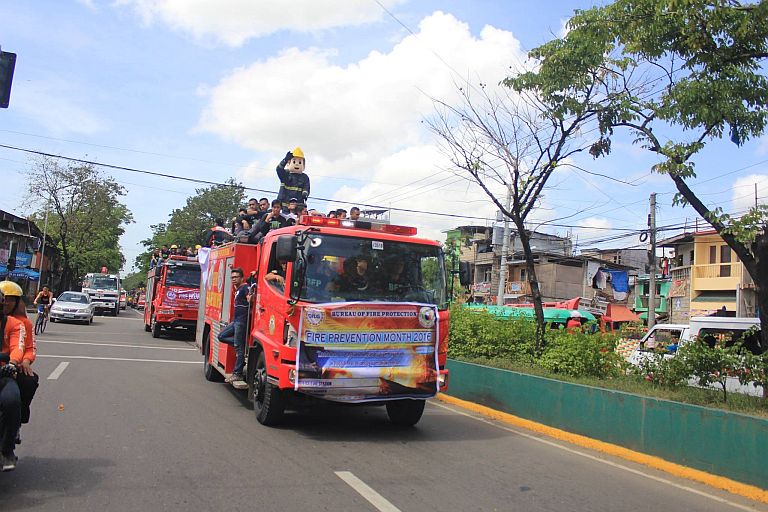 'Berong Bumbero,' the mascot of Bureau of Fire Protection Central Visayas (BFP-7) waives at passersby during the caravan that ushered March, dubbed as the Fire Prevention Month (CONTRIBUTED PHOTO)