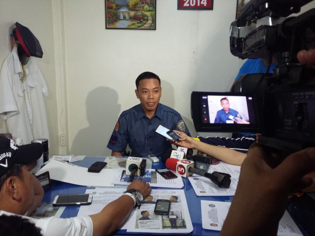 Clad in a police uniform, Dojie Canido fields questions from news reporters after his arrest last Sunday. (CDN PHOTO APPLE MAE TA-AS)
