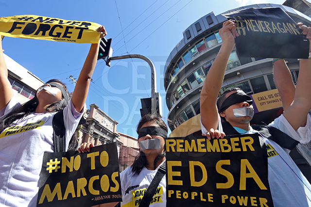 EDSA ANNIVERSARY RALLY. Members of the Anakbayan Youth wear blindfolds and tape their mouths to depict how the Marcos regime blinded and silenced the youth during their rally in Colon. The nation commemorated yesterday the 30th anniversary of the first People Power Revolution. (CDN PHOTO/JUNJIE MENDOZA)