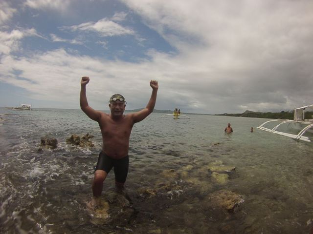 PINOY AQUAMAN. Lawyer Ingemar Macarine celebrates after reaching the beach of Baclayon town, Bohol. He successfully swam 15-kilometers in open seas from Pamalican Island, Bohol last Sunday. (FACEBOOK PHOTO)