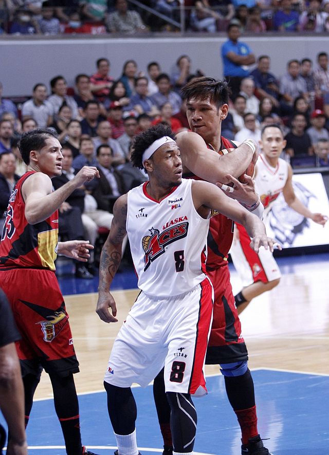 Cebuano June Mar Fajardo of San Miguel secures the ball from Alaska’s Calvin Abueva in Game 7 of the PBA Philippine Cup Finals. (PBA IMAGES)