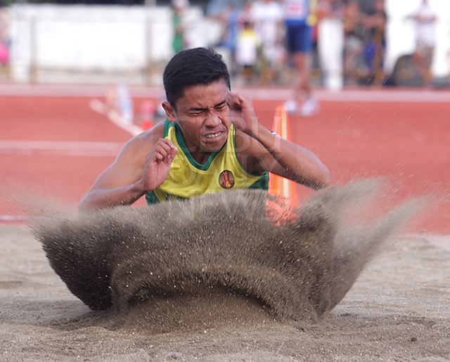 Seth Abram of Cebu City completes his attempt in the secondary long jump event of the CCVIRAA at the Teodoro "Doring" Mendiola Sr. Sports Field and Oval in the City of Naga. (CDN PHOTO/TONEE DESPOJO)