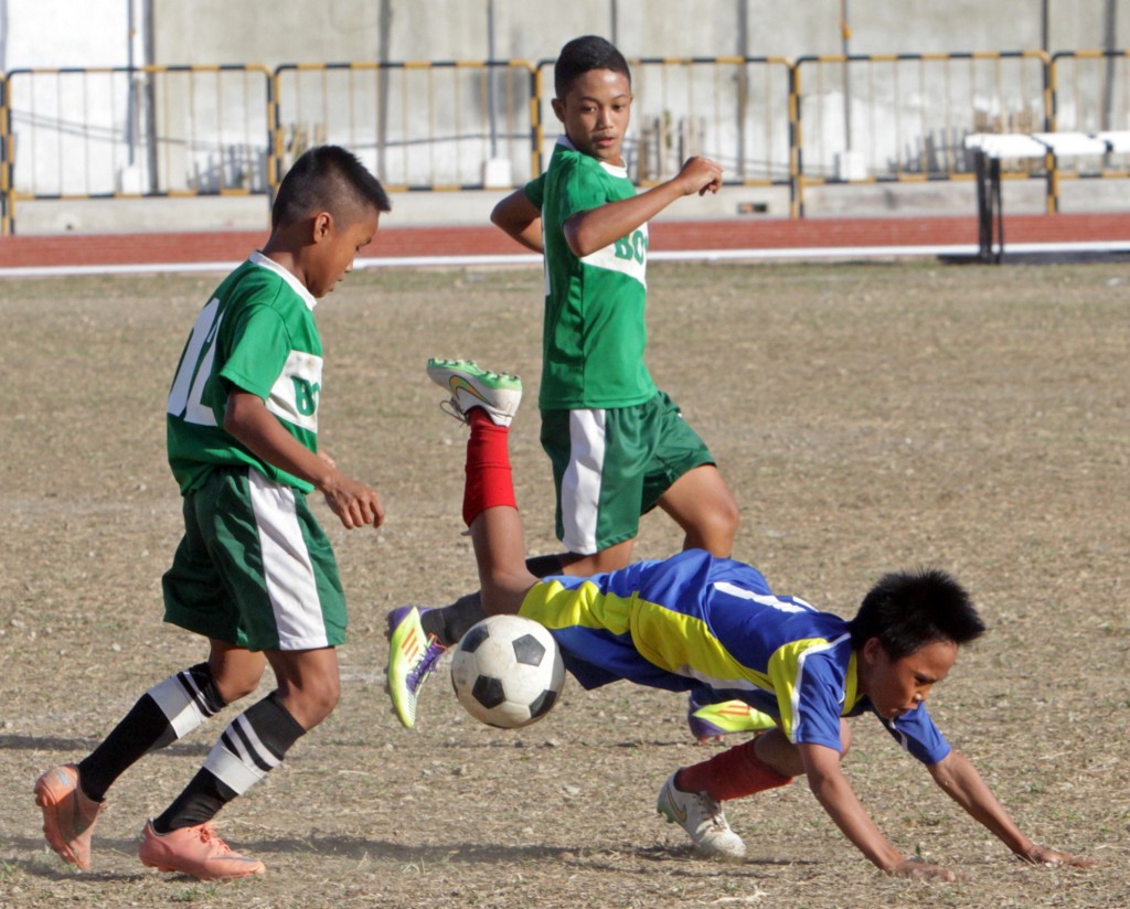 A Cebu Province booter trips in a game against Bohol Province at the Teodoro “Doring” Mendiola Sr. Sports Field and Oval at the City of Naga.  CDN PHOTO/LITO TECSON