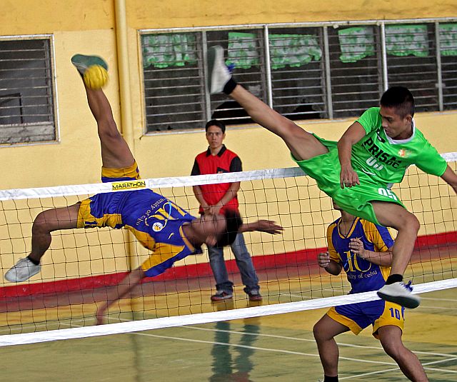 Jacky Calabaryo of UC scores on a spike against Bohol during their men’s sepak takraw game in the PRISAA Regional Meet at Cebu City Sports Center. (CDN PHOTO/LITO TECSON)