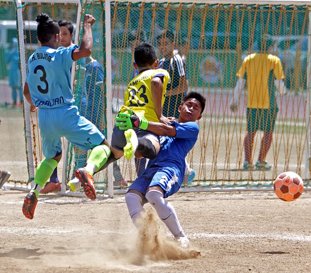 THIRSTY FOOTBALL CUP 2016/FEB.21,2016:Don Bosco booter and Goal Keeper collide in med air while FCI booter looks on during their game in Thirsty Football cup 2016 at Cebu City Sports center.Tie game.(CDN PHOTO/LITO TECSON)