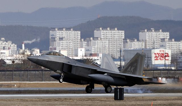 One of four US F-22 stealth fighters lands at Osan Air Base in Pyeongtaek, South Korea. (AP PHOTO)