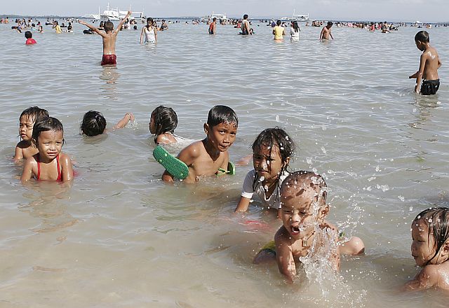 Children have fun in a beach in Lapu-Lapu City in this 2008 file photo.