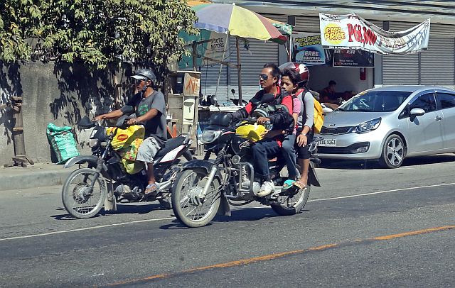 SILOYS WATCHING LILOAN/MARCH 16,2016:Two motorcycle riders the one in the left wear unpresscribe helmet and the right no helmet with overloading passengers these riders are these two riders spotted in the high way of Lilo-an town.Did the knows the LTO motorcycle driving safety tips.Attention LTO why dont you widen your campaign on wearing safety helmet in the provinces of Cebu.(CDN PHOTO/LITO TECSON)
