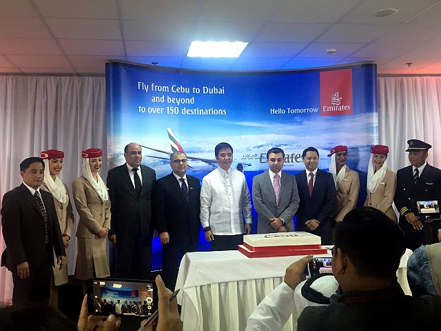 The Emirates Airlines inaugural flight from Dubai arrives at the Mactan  Cebu International Airport (left photo). At right, Emirates executives, together with Transportation Secretary Joseph Emilio Abaya (6th from left) and GMR Megawide Cebu Airport Corp. president Manuel Louie Ferrer lead the ceremonial cake-cutting ceremony at the MCIA. CDN PHOTOS/VANESSA CLAIRE LUCERO