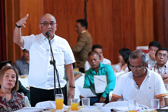 National Food Authority (NFA) Asst. Regional Director Nestor Alcoseba (standing left) explains why NFA supplies were not delivered to western towns during the Provincial Development Council meeting at the Capitol Social Hall. (CDN PHOTO/JUNJIE MENDOZA)