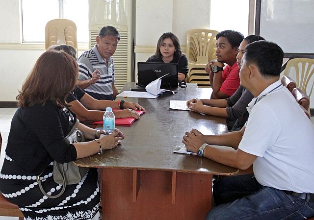 EMB COAL ASH HEARING/MARCH 10,2016:Atty. Fernando Alberca Chief Legal Division and Hearing Officer of EMB talk to complainant Estrella Manloloyo and Violeta Musngi regarding the coal ash they complaint against the Representative Armen Sumampong (back to the camera with white shirt) during their technical conference at the EMB conference room.(CDN PHOTO/LITO TECSON)