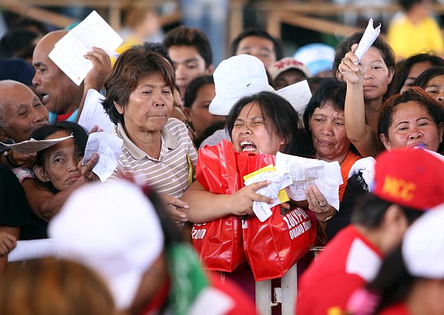 LOLYPOP OAUNO GAVE RELIEF GOODS TO MANDAUE FIRE VICTIMS/MARCH 15,2016:Fire victims who recieved her relief goods gremaces in pain as she tried to get out of the area.The relief goods is given by Mandaue City Councilor and Mayorality Candidate Lolypop Oauno Dizon at CICC.(CDN PHOTO/LITO TECSON)