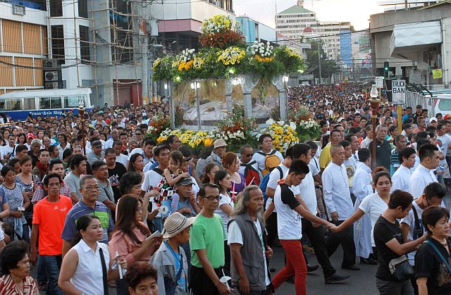 Thousands crowd Osmeña Boulevard to join the Good Friday procession (left) while devotees touch the wooden cross after the “Seven Last Words” of Jesus Christ held at the Cebu Metropolitan Cathedral.