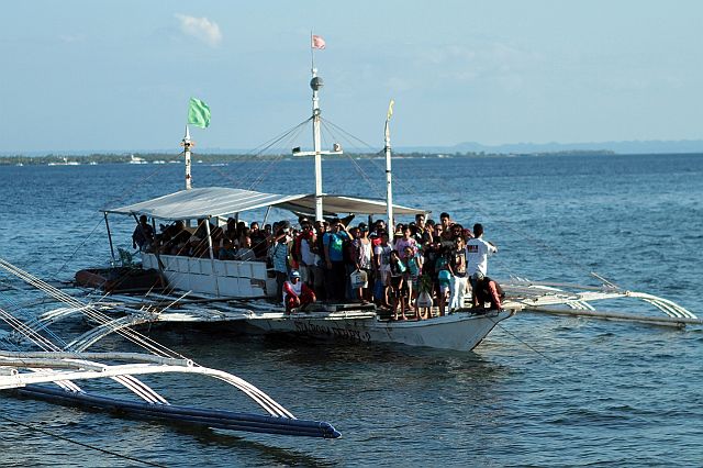 A motorized banka "STA ROSA FERRY 2"  from Olango Island ready to dock at Angasil pier in Barangay Mactan, lapu-lapu City did not mind the danger of being over loaded with passengers despite the 50 passenger capacity painted on the side of the boat, the other day Easter Sunday.(CDN PHOTO/FERDINAND EDRALIN)