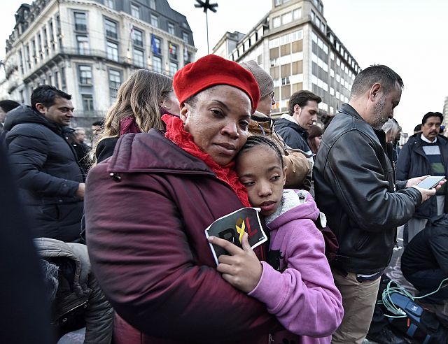 People gather at the Place de la Bourse in the center of Brussels to mourn for bombing victims. (AP)