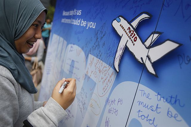 A Malaysian woman writes well wishes on a wall of hope during a remembrance event for the ill-fated Malaysia Airlines Flight 370 in Kuala Lumpur, Malaysia, Sunday, March 6, 2016. At the commemorative event Sunday to mark the second anniversary of the jet’s March 8, 2014, disappearance, the families of Flight 370 passengers released white balloons tagged with the names of everyone aboard the plane and the words: “MH370: Always remembered in our hearts.” (AP PHOTO)