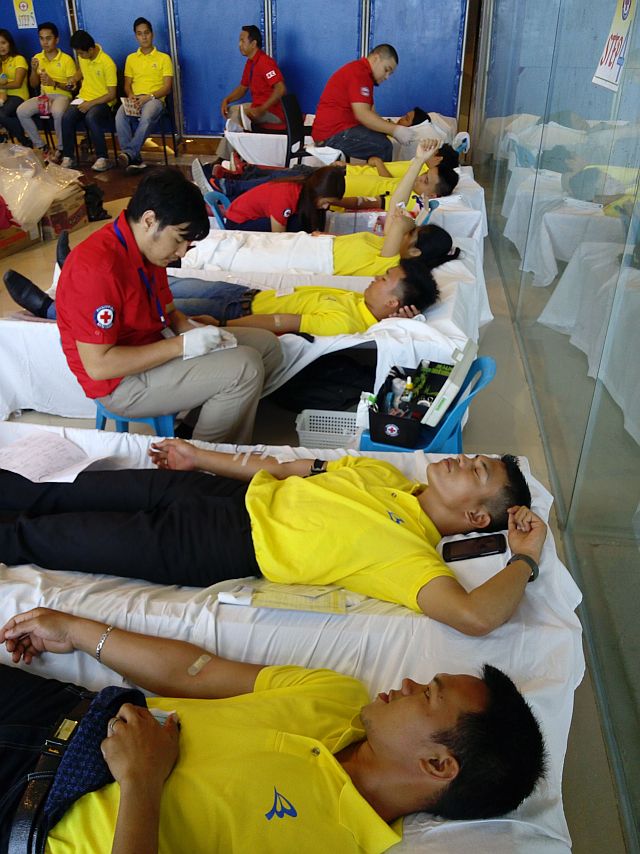 Red Cross personnel assist members of the World Mission Society Church of God in donating blood. (CONTRIBUTED)