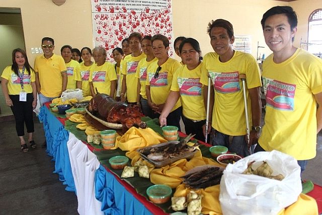 Pantawid beneficiaries in Naga City launch their livelihood project La Familia’s Lechon. With them is SLP Project Development Officer John Paul Peca (extreme right). (CONTRIBUTED) 