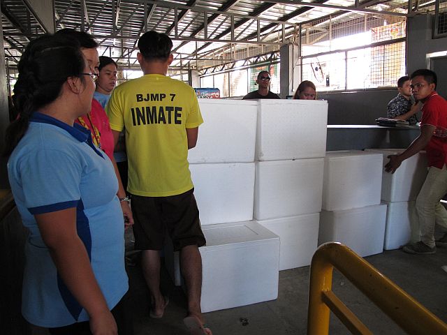 JIKFI volunteers prepare the buckets of meals that were distributed to Mandaue inmates. (CONTRIBUTED) 