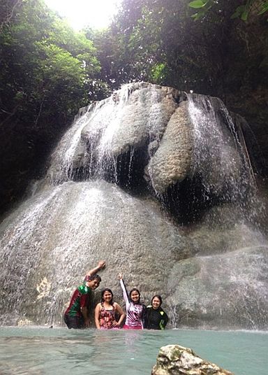 Traveler blogger Chito Patiño (left) is mesmerized by Aguinid Falls’ multiple tiers.  He lauded the local  government unit that  manages the area for preserving the   natural  beauty of this tourist attraction. (CONTRIBUTED PHOTO)