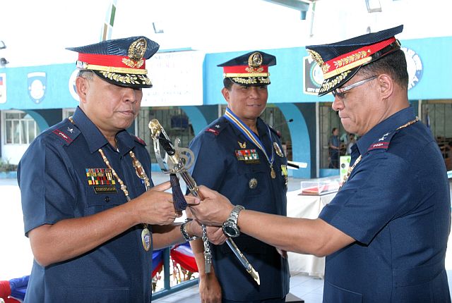 PRO7 TURN OVER OF COMMAND/APRIL 4, 2016:Police Chief Supt. Patrocinio Comendador (left) recieves the PNP command sword as new director of the Police Regional Office in Central Visayas from Police Director Dominador E. Aquino,Jr., PNP director for personel and records management, Camp Crame after it was hand over from out going director Police Chief Supt. Manny Gaerlan (center) during the turn over ceremony in Camp Sergio Osmeña Sr.(CDN PHOTO/JUNJIE MENDOZA)