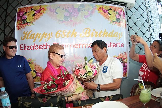 Elizabeth Zimmerman Duterte/APRIL 14,2016: Davao Mayor Rodrigo Duterte greeted her wife with a happy birthday with bouqet of flowers and a kiss during his surpirse visit at the 68 birthday celebration Elizabeth Zimmerman-Duterte yesterday afternoon.The kiss was witnessed by their children Paolo and Sarah Duterte. (CDN PHOTO/FERDINAND EDRALIN)