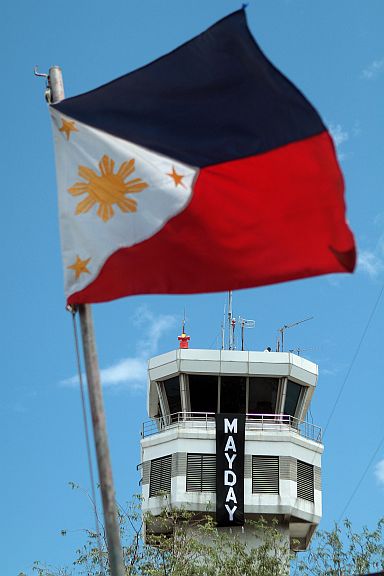 CAAP DISTRESS CALL/APRIL 15, 2016: MCIAA CAAP employees joined the nationwide silent protest by sending DISTRESS CALL to the Philippine President by hanging a black banner at the airport control tower yesterday morning.(CDN PHOTO/FERDINAND EDRALIN)