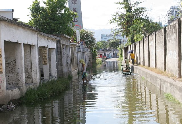 The entrance to one of Cebu City’s public cemeteries is flooded after the early morning rain. (CDN PHOTO/JUNJIE MENDOZA)