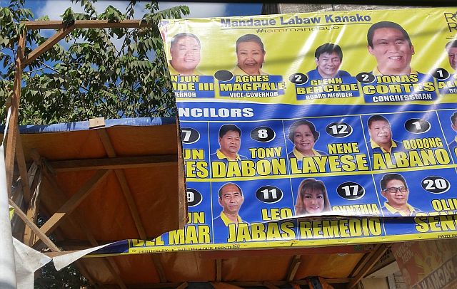 The campaign tarpaulin of Mandaue City mayoral candidate Lolypop Ouano  of One Cebu  (left)  is defaced while the billboard of her rival in the race, outgoing sixth district Rep. Luigi Quisumbing  (Liberal Party), is destroyed allegedly by supporters of the rival parties. (CONTRIBUTED PHOTOS)